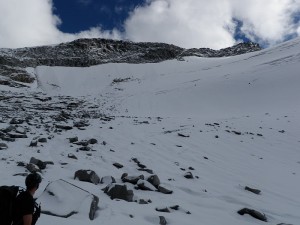 At the base of the glacier looking back at the route. Sloughs visible where the glacier meets the rock.